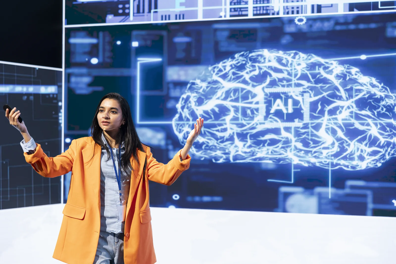 Presenter in front of an AI brain display